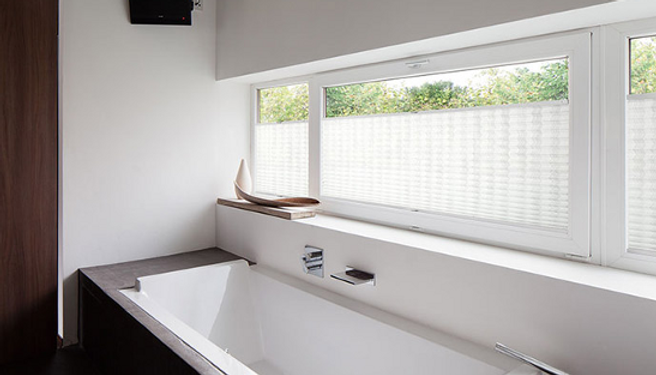 Custom Roman shades with elegant fabric folds in a classic New York City interior