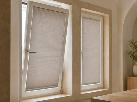 Tensioned pleated shade aligned to a tilted European window sash