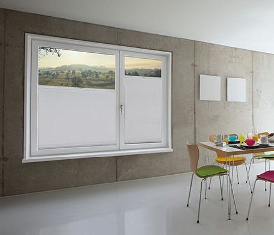 SKIRO bottom-up roller shade raised from the bottom sill for privacy with light above